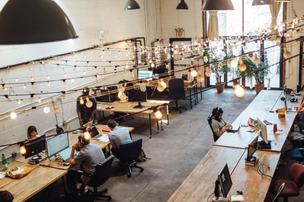 Coworking office filled with several new employees working on their computers