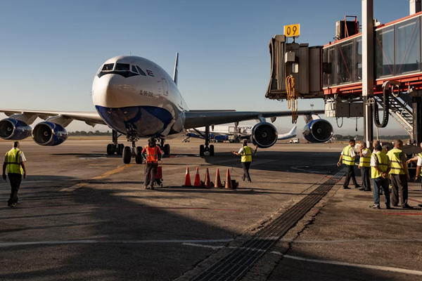 Employees loading cargo on transport vehicles at the airport