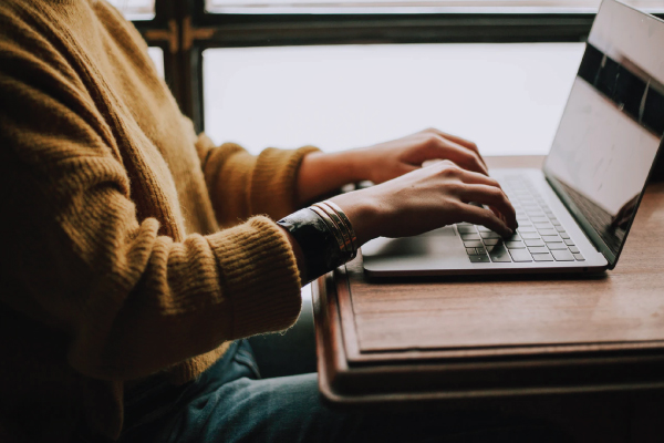 Employee siting at desk working on their laptop