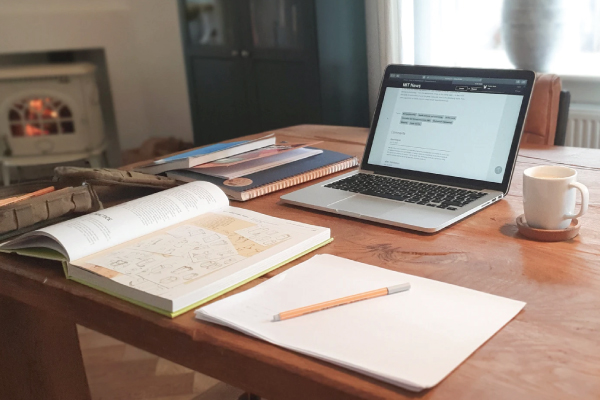 home office desk with a notebook and laptop