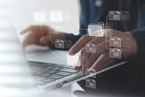 Man on laptop with files overlay